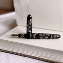 CYPRESS × @micahfinds Victorian Flora: Lily of the Valley's Invitation Fountain Pen On Top Of Blank Notebook | EndlessPens