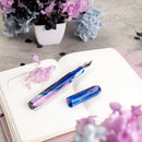 Franklin-Christoph Model 46 Hydrangea Nights Fountain Pen - Pen and Cap Cover on Top of Notebook | EndlessPens