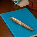 Kilk Orient Beige Fountain Pen (2024) - Pen On Top Of Blue Notebook | EndlessPens