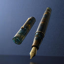 Leonardo Momento Zero 2026 Pausilya Fountain Pen (14K Gold) - Pen and Cap Cover in Blue Background | EndlessPens