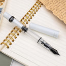 Monteverde MP1 White Lotus Fountain Pen - Pen and Cap Cover on Top of Notebook | EndlessPens